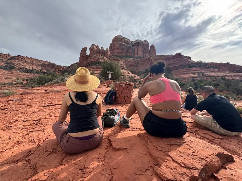 group sitting at energy vortex cathedral rock in Sedona Spiritual Retreat